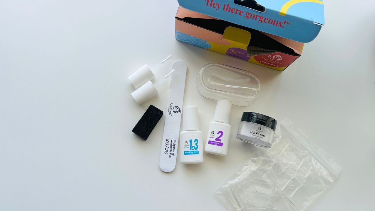 The Beetles Nail Dip Powder Apex Kit opened on a white table for the best dip powder nail kits.