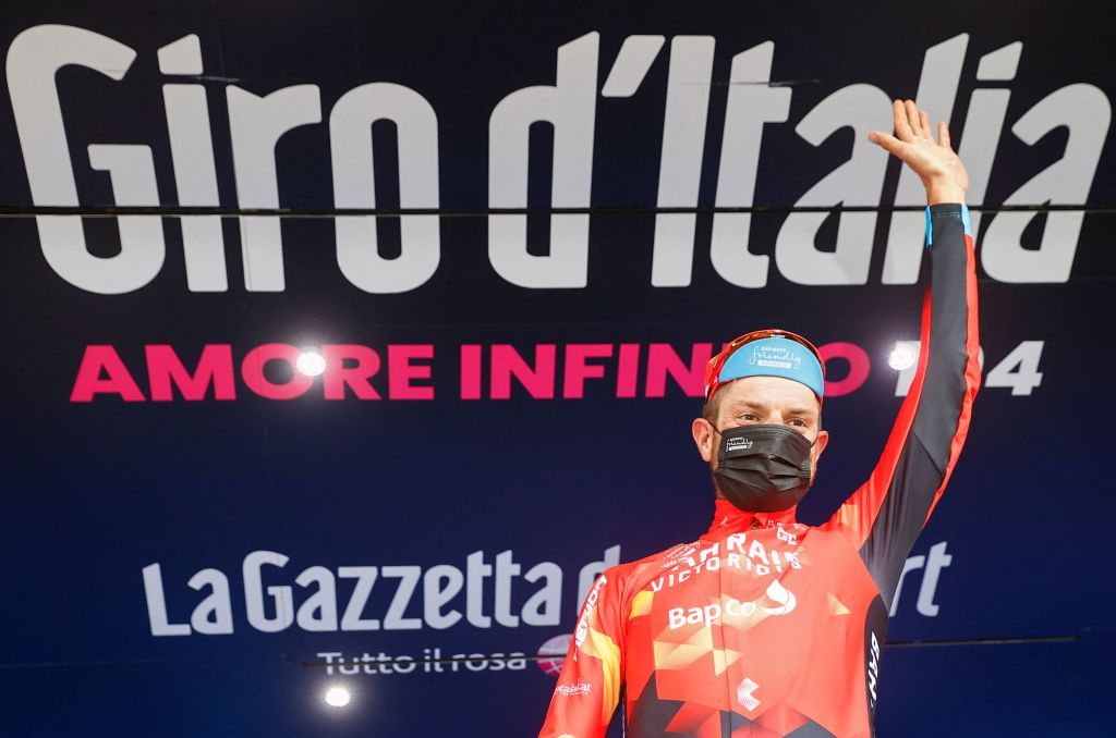 Team Bahrain rider Italys Damiano Caruso celebrates on the podium after winning the 20th stage of the Giro dItalia 2021 cycling race 164km between Verbania and Valle Spluga Alpe Motta Madesimo on May 29 2021 Photo by Luca Bettini AFP Photo by LUCA BETTINIAFP via Getty Images