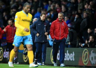 Former Crystal Palace caretaker manager Keith Millen (right) and coach Ben Garner (centre) walk down the touchline