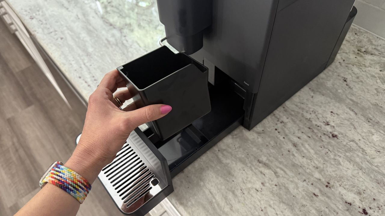 Terra Kaffe Demi cleaning out waste bin and drip tray