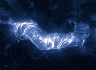 One million degree hot solar plasma travels along magnetic loops in the sun's atmosphere during the Bastille Day solar storm of 2000.
