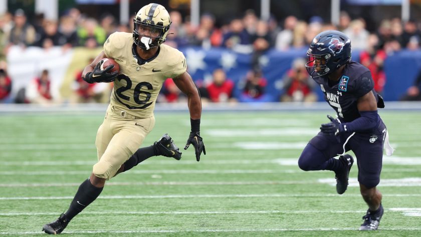 Army Black Knights player Kanye Udoh pursued by Navy Midshipmen&#039;s Mbiti Williams Jr in the Army vs Navy football match in 2023