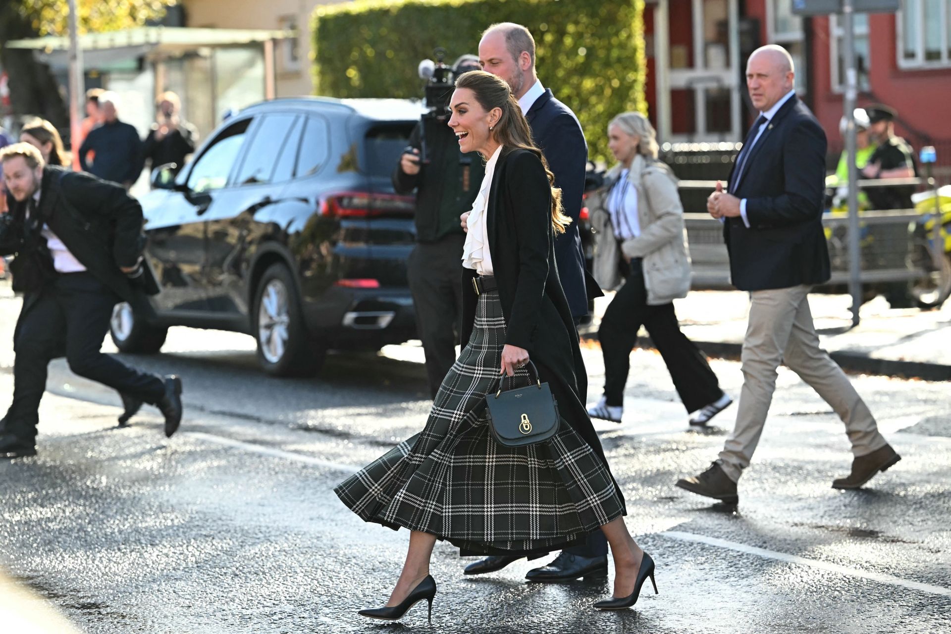 Princess Kate walking in a green plaid skirt