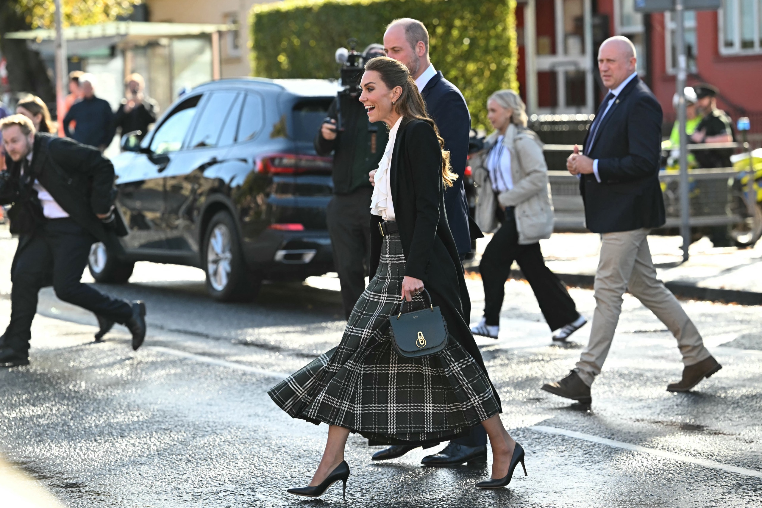 Princess Kate walking in a green plaid skirt