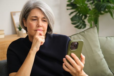 Older woman looking at her phone