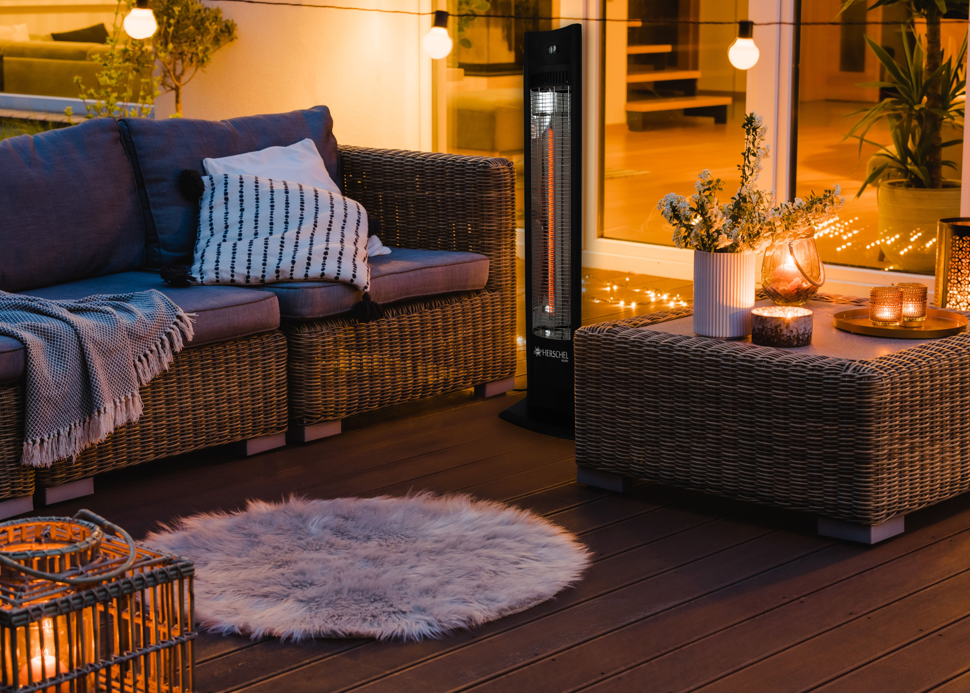 outdoor seating area with sofa, coffee table and a fluffy carper and outdoor heaters
