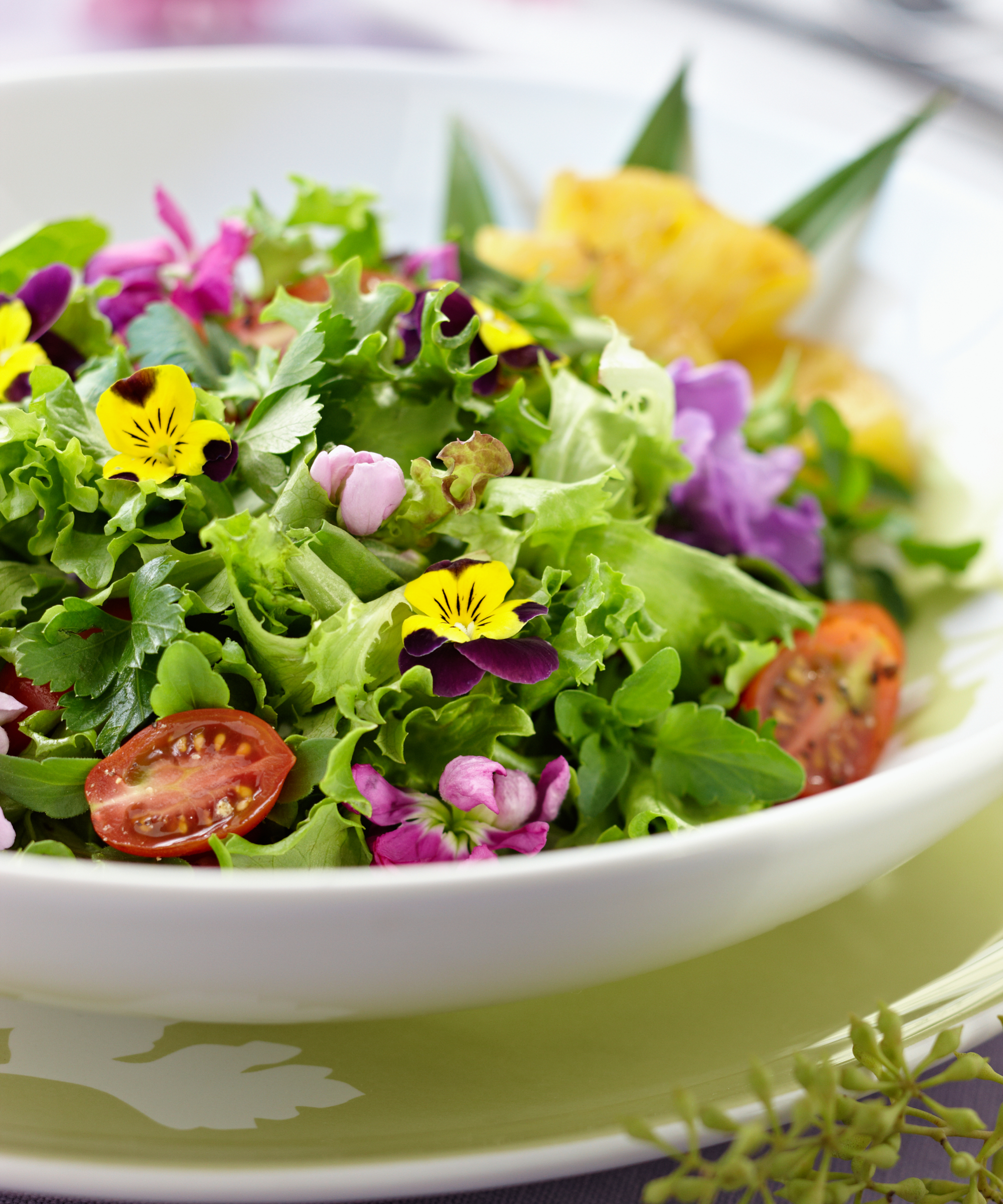 bowl of salad with edible flowers