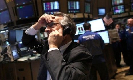 A New York Stock Exchange trader reacts to the news that S&amp;amp;P cut America&amp;#039;s credit outlook. The ratings agency cited Washington&amp;#039;s political gridlock as one reason for the downgrade.