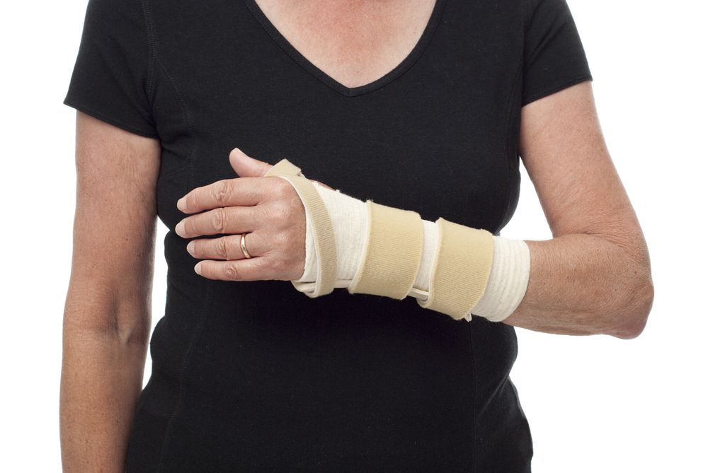 A woman wears a splint on her forearm and wrist.