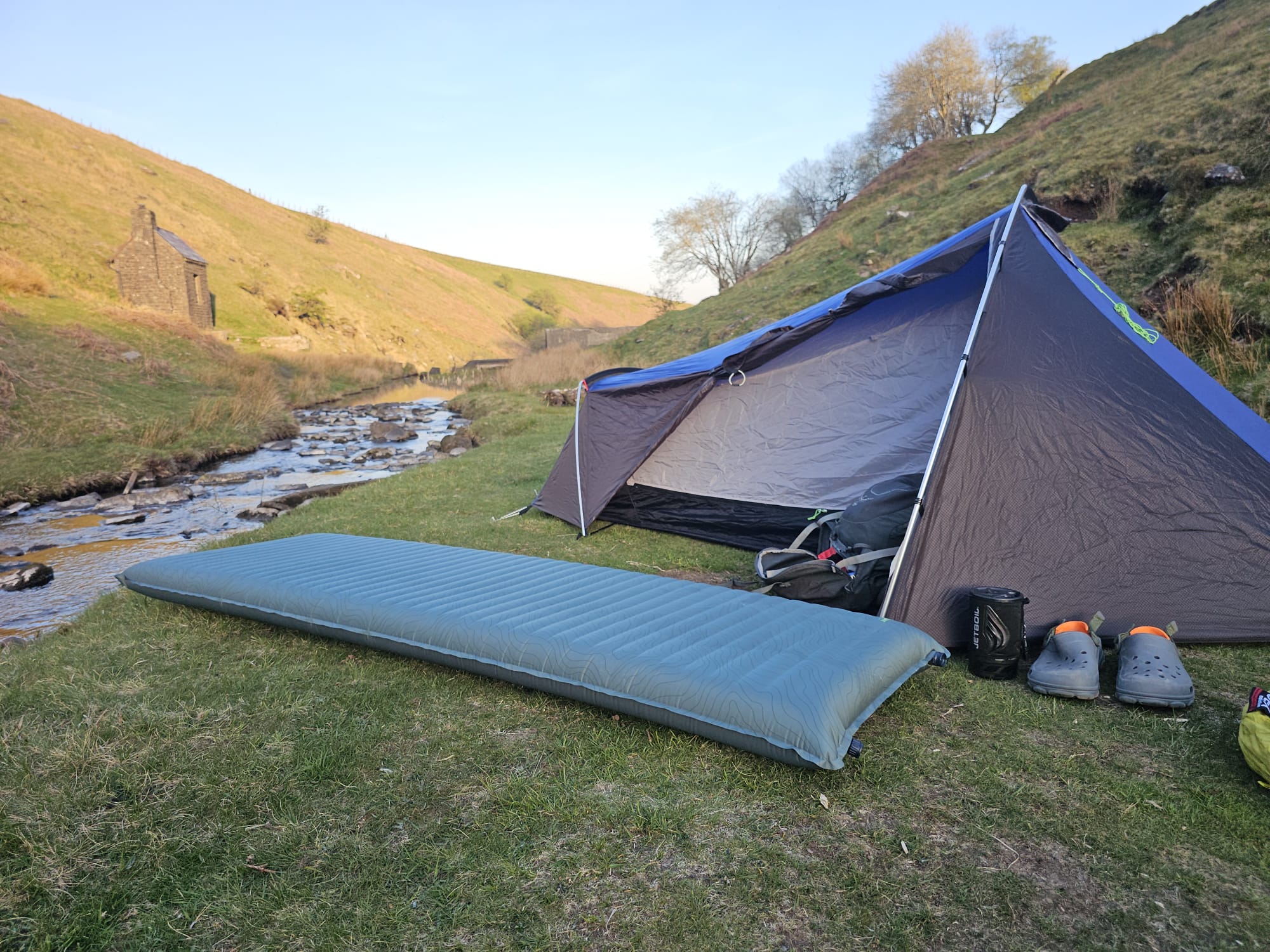 Thermarest sleeping mat shown in front of a backpacking tent