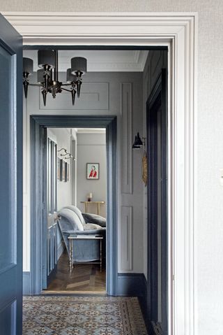 Blue and grey hallway with patterned tiles