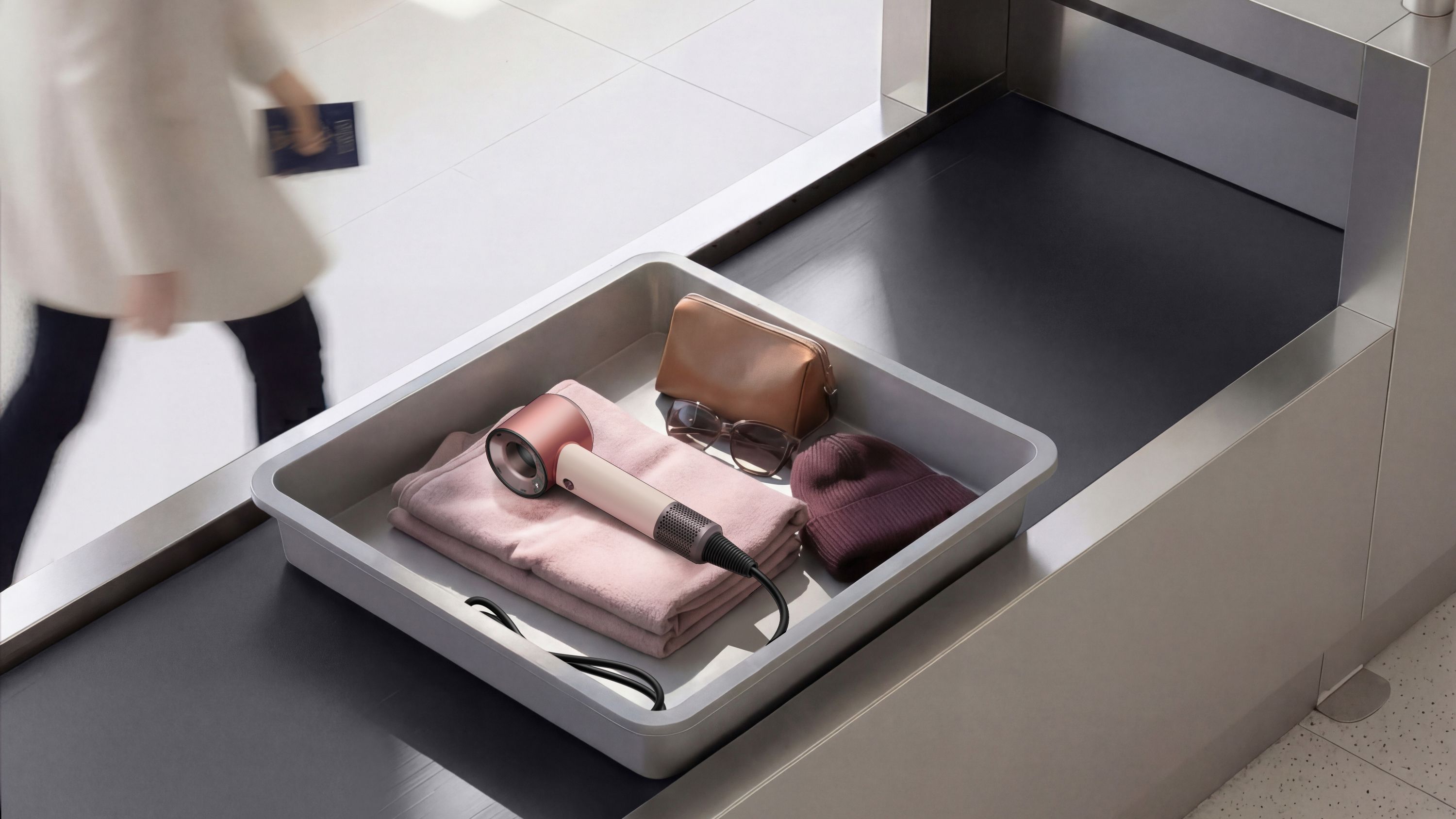 Dyson Supersonic Travel hair dryer in a tray at airport security