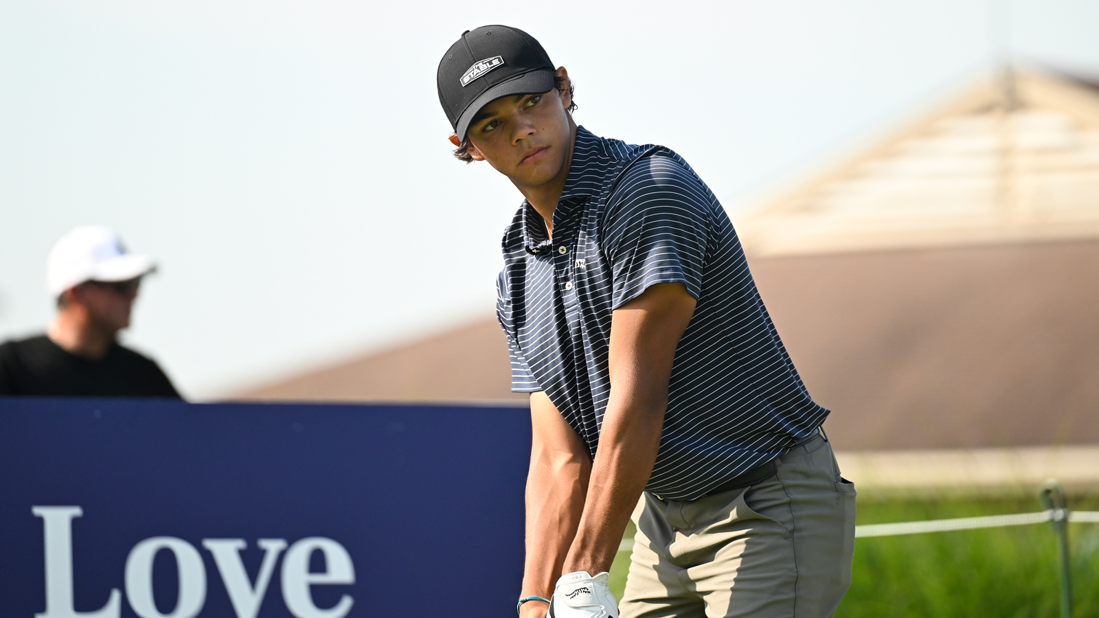 Charlie Woods stands over a tee shot