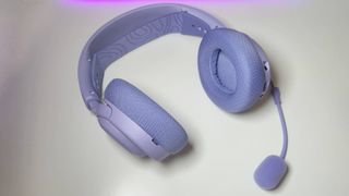 Photos of the SteelSeries Arctis Nova 3 Wireless gaming headset in Lavender sitting on a white desk.
