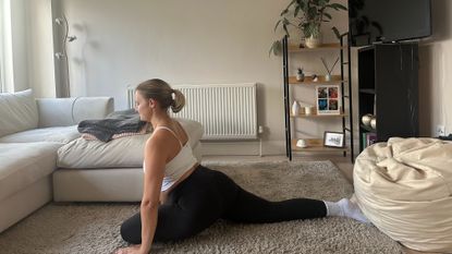Fitness writer Alice Porter performing a hip mobility stretch