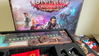 The Divinity Original Sin: The Board Game box and contents against a white surface