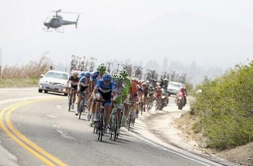 The peloton is chased up the hill by the television helicopter
