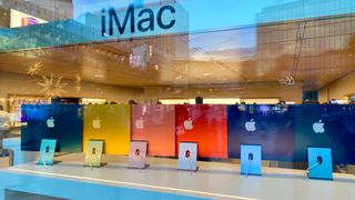 Brand new 2021 colorful iMac’s in Apple Store. Customers are waiting in line to get new products from Apple.