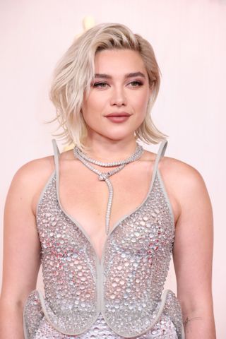 Florence Pugh with short blonde layered hair.