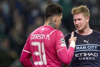 Ederson and Kevin De Bruyne celebrate a Manchester City win over Sporting CP in the Champions League in February 2022.