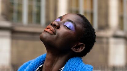 A model wears purple eyeshadow and red lipstick on February 29, 2020 in Paris, France. 