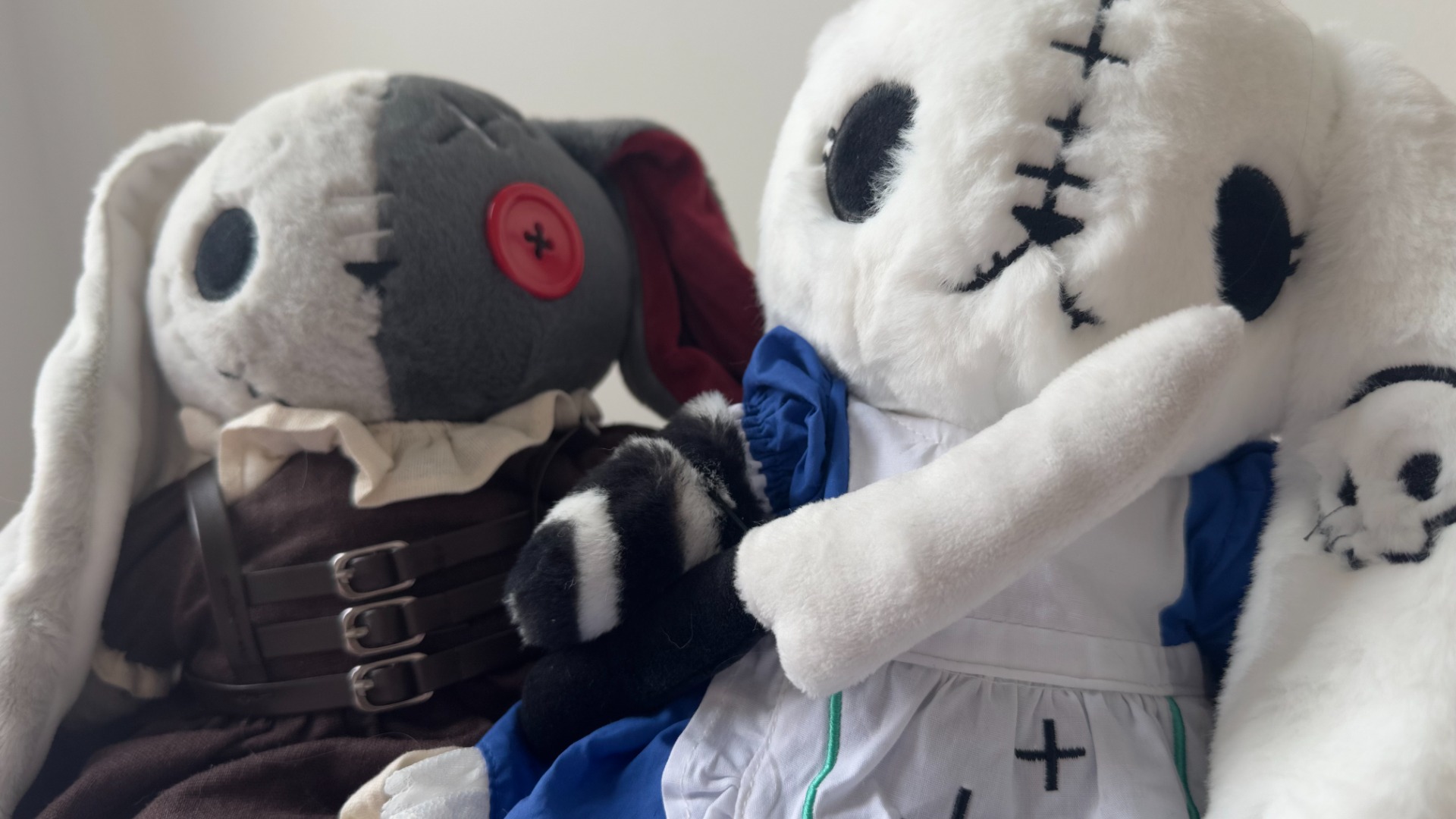 The Alice plush holds a stuffed Vorpal Blade next to the Little Red Riding Hood plush