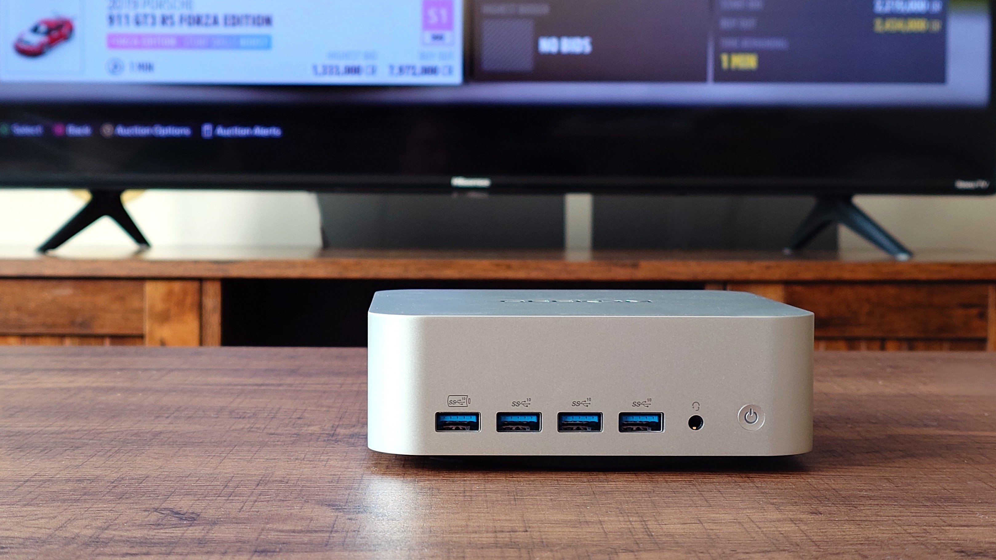 Geekom A9 Max front view showing four USB 3.2 ports, the power button and headphone jack.