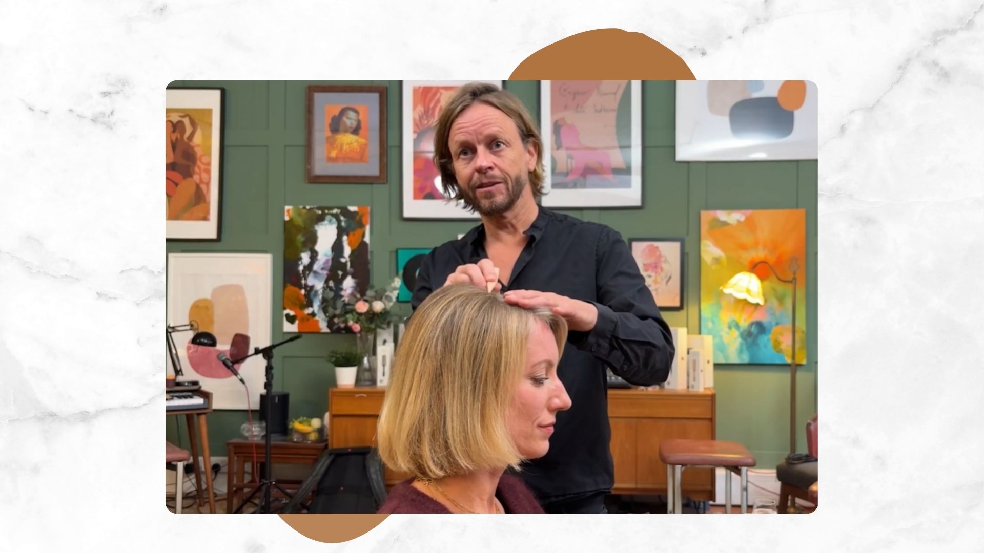 Michael Douglas shown styling the hair of woman&amp;home lifestyle editor Tamara who has a blonde bob, in a green room with paintings on the wall