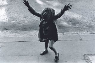 Girl about to do a handstand, Kensal Road, 1957