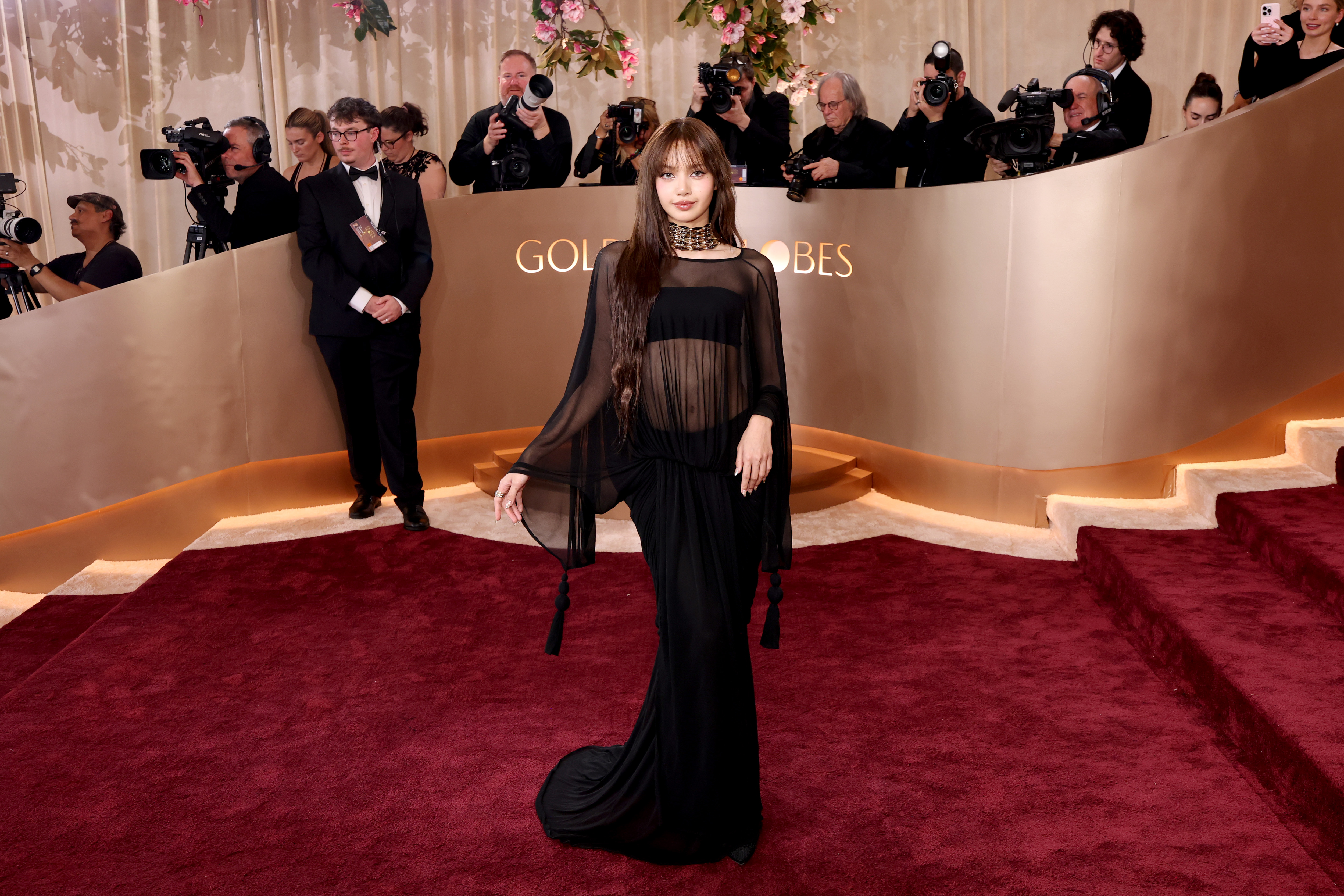 Lisa arrives at the 2026 Golden Globes red carpet wearing a sheer black dress