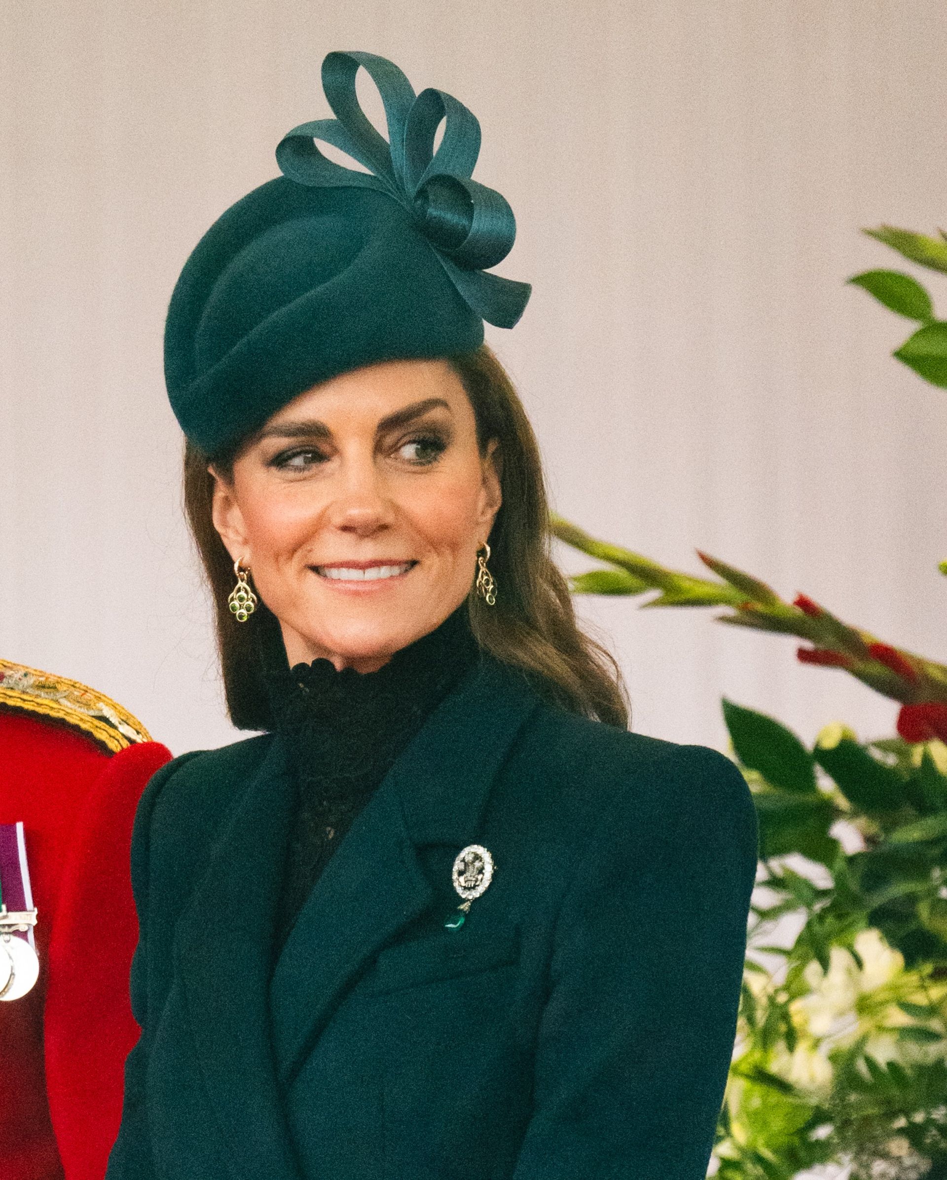 Princess Kate wearing a green coat and hat