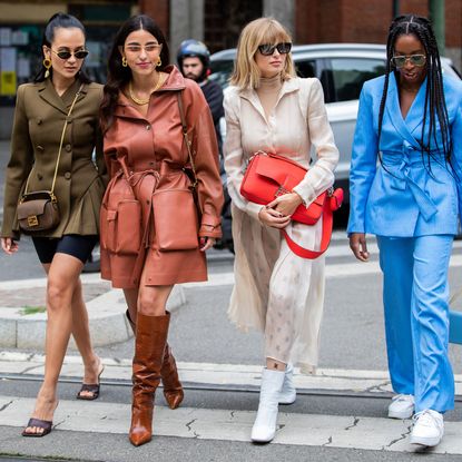 Anna Rosa Vitiello wearing cycle pants, olive double breasted jacket, Fendi bag, Bettina Looney wearing rusty brown coat, boots, Xenia Adonts wearing red Fendi bag, creme white dress, Chrissy Rutherford wearing blue jacket and pants seen outside the Fendi show during Milan Fashion Week Spring/Summer 2020 on September 19, 2019 in Milan, Italy.