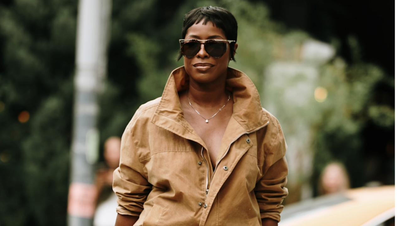 woman wearing all tan and sunglasses in new york city.