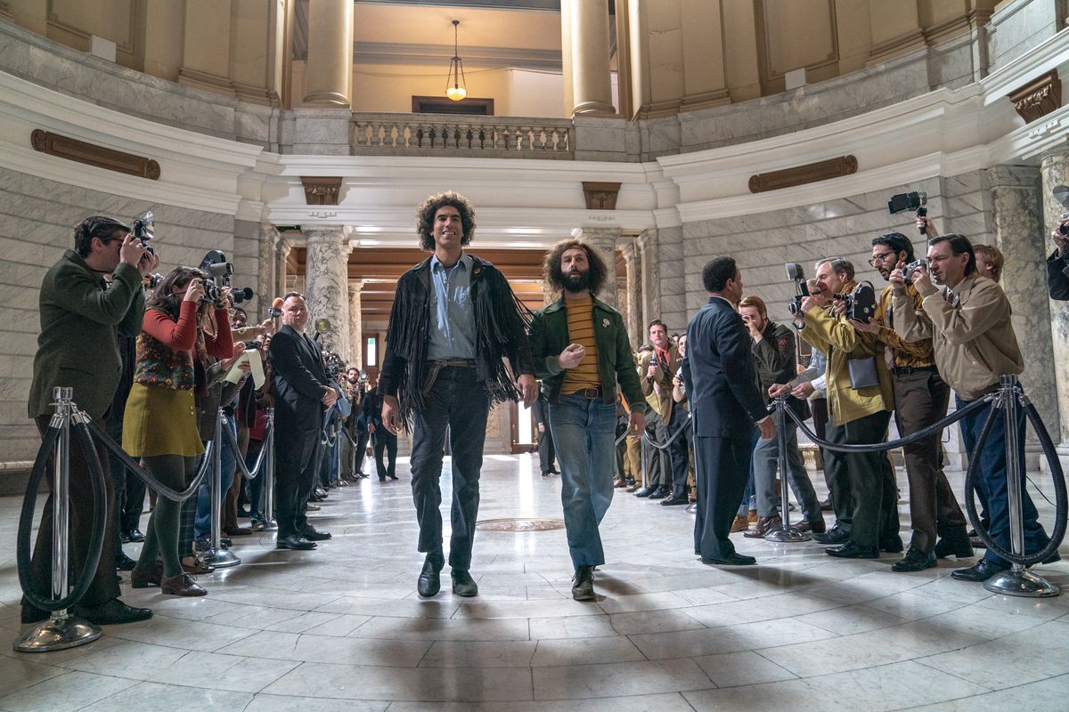 Sacha Baron Cohen as Abbie Hoffman and Jeremy Strong as Jerry Rubin in The Trial of the Chicago 7.