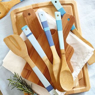 Wooden spoons and utensils on wooden chopping boards