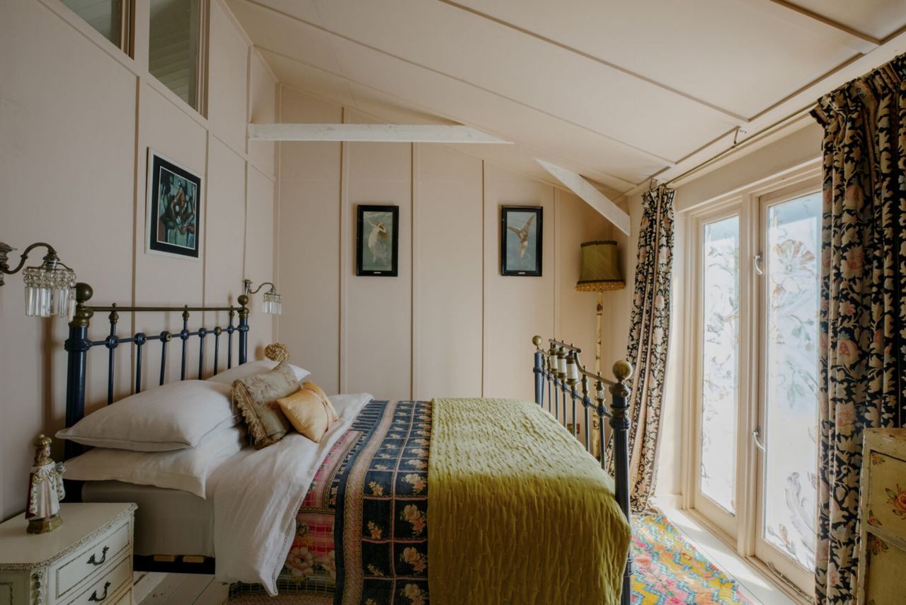 Another bedroom with bifold doors and slanted roof