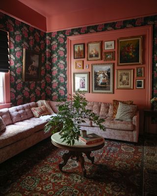 Pink living room with wallpaper and gallery wall