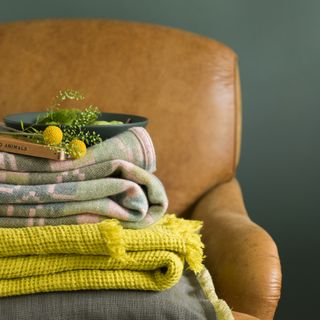 leather chair piled with blankets