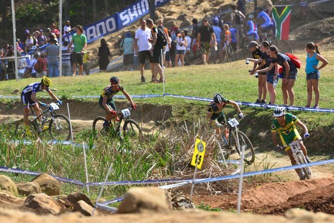 Riders head through Buck Jump Alley in the Junior Men's Cross Country