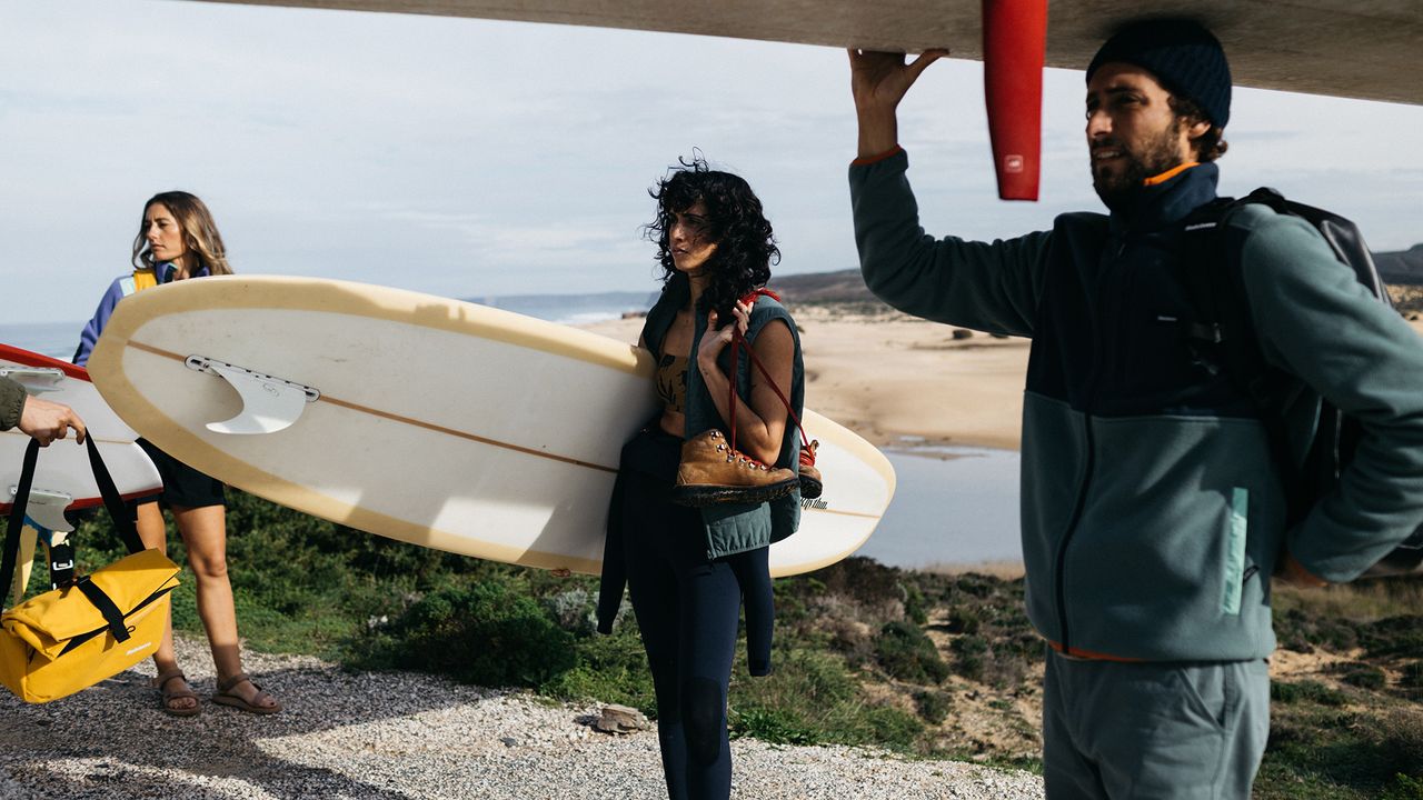 People spending time outdoors wearing Finisterre clothes and wetsuits