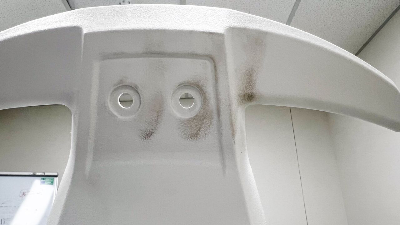 Dirty fingerprints on the rear of the white plastic frame of the Desky Swivel 3D Tilt office chair