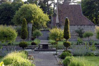 Looking across the kitchen garden and its formal pool towards the old coach house at Voewood. Val Corbett/Country Life