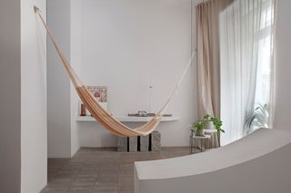 A minimalist living room with a hammock