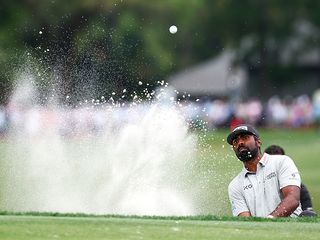 Sahith Theegala playing a bunker shot on the golf course