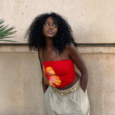 A woman with curly hair against a wall