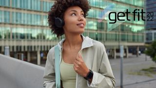 Thoughtful young woman wearing fitness tracker