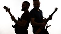 Two Guitarists Performing Back To Back