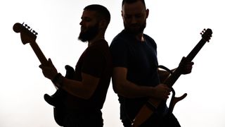 Two Guitarists Performing Back To Back