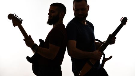 Two Guitarists Performing Back To Back