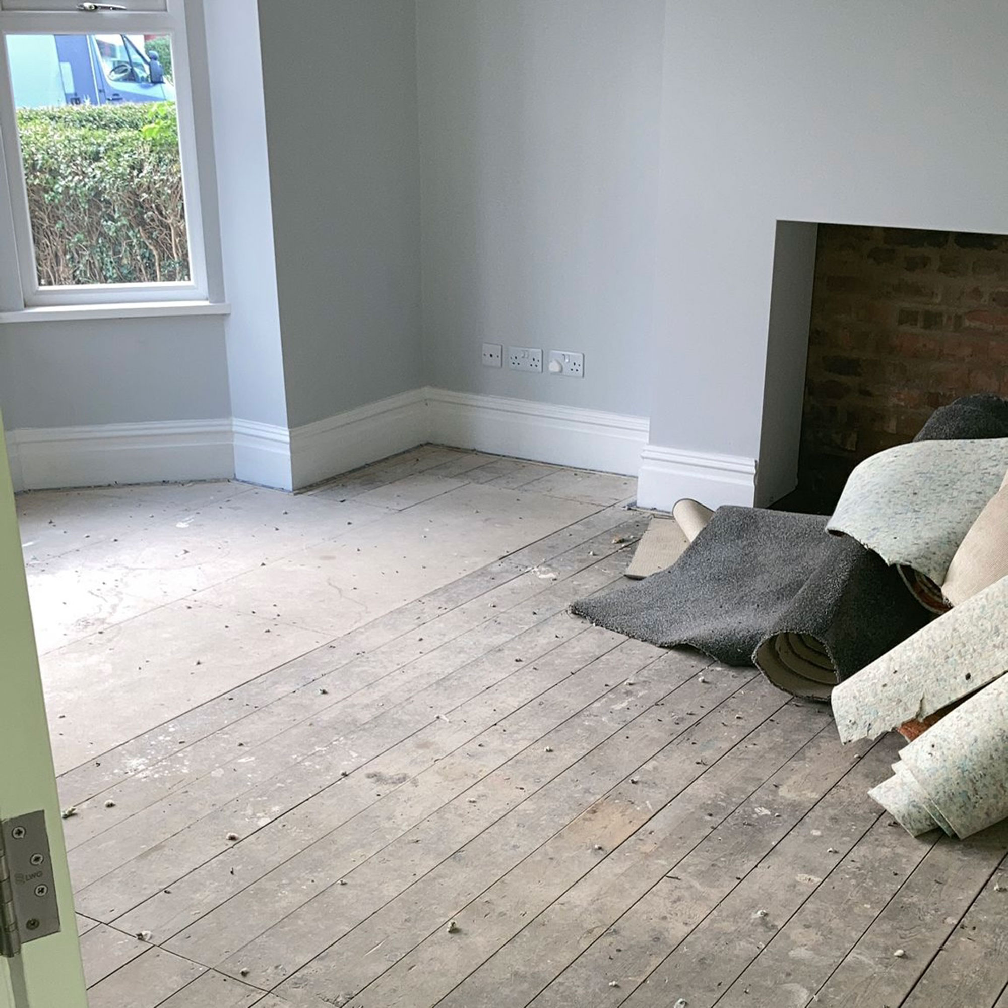 Empty grey living room with bare wooden floor